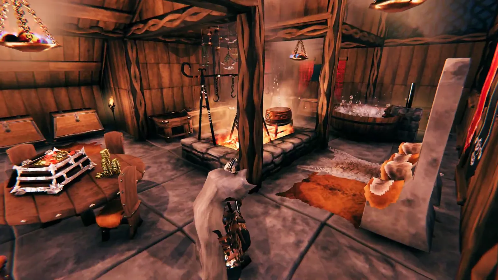 The warm interior of a Viking longhouse with a hearth, dining table, and bath