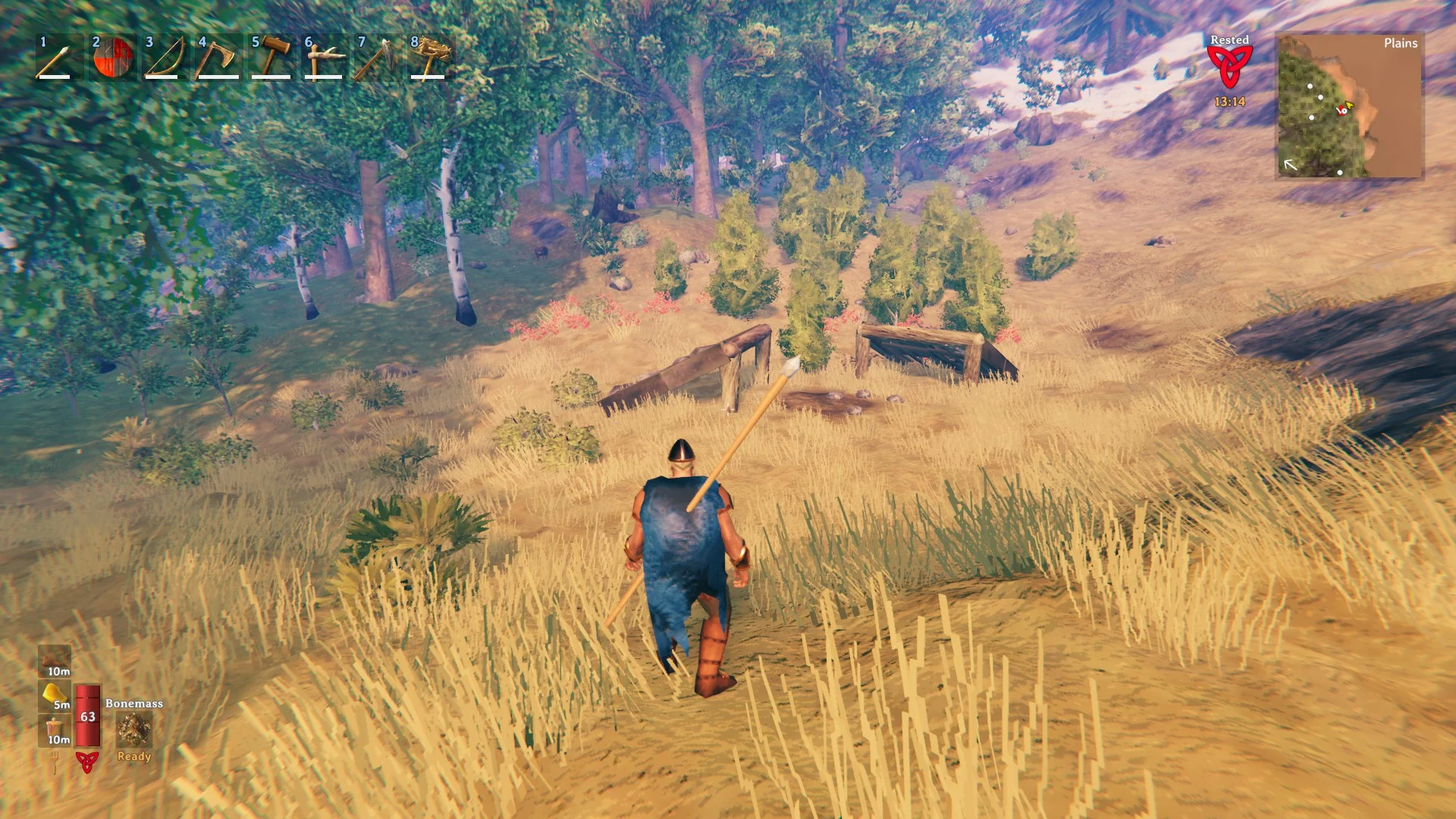 A Viking crossing an open meadow toward the forest